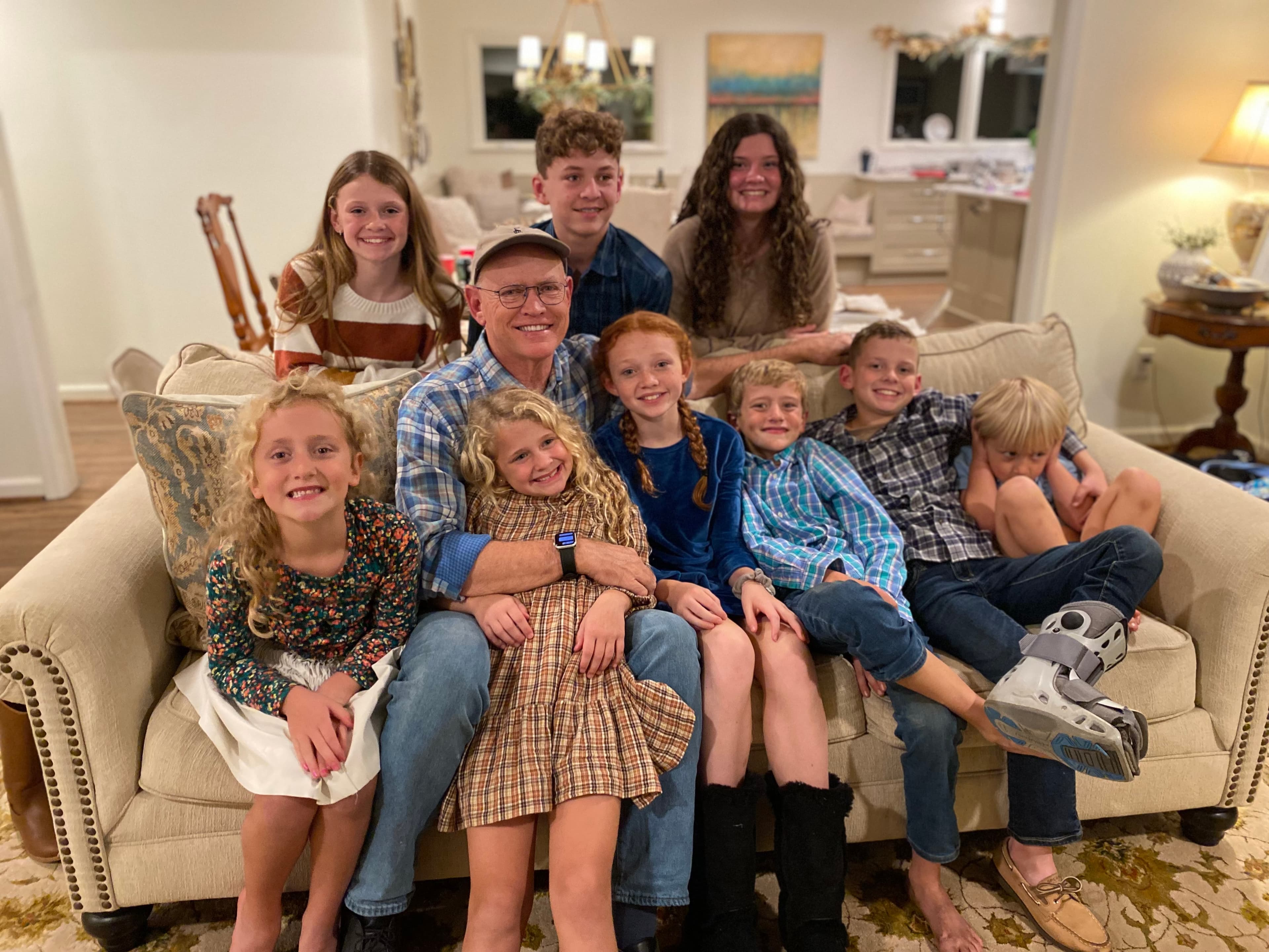G.B. Sollie, author of Cat Luker series, smiling with his family members including grandchildren